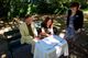 Sylvie helping the bride and groom sign the official paperwork.