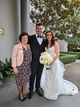 Sylvie standing with the bride and groom.