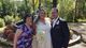 Sylvie standing with the bride and groom in front of a fountain.