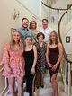 Sylvie standing with the family on a staircase.